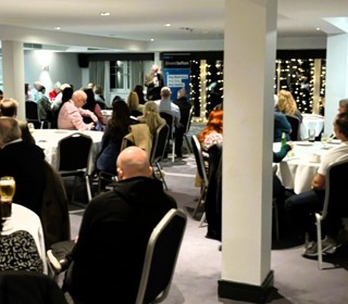 Crowd of seated people listening to presentation 