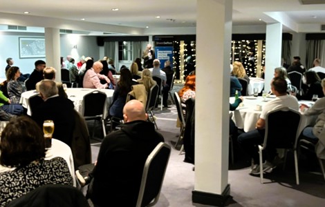 Crowd of seated people listening to presentation 