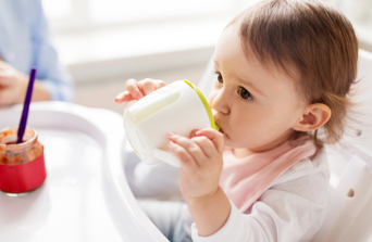 baby drinking out of cup