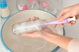 persons hands washing dishes