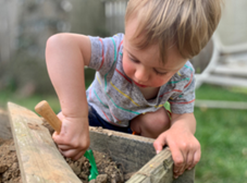 child playing with a spade