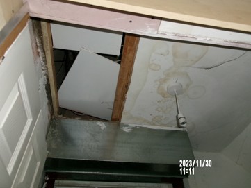 A broken ceiling and water damage around a light fitting.