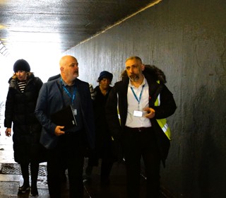 Group of people walking through subway